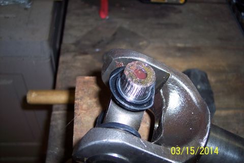 1973 Ford F-250 - Close-up of a metal automotive part, possibly from a steering or suspension system, with a visible bolt and seal.