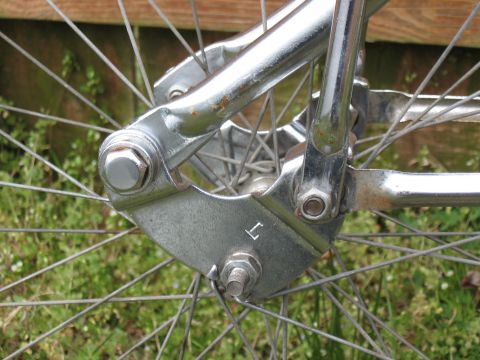 1994 Ford Bronco - Close-up of a bicycle's chrome fork and wheel assembly against a grassy background.