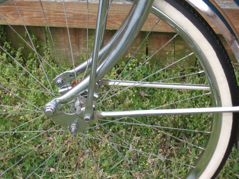 1994 Ford Bronco - Close-up of a bicycle's wheel and frame, showing chrome details and a whitewall tire.