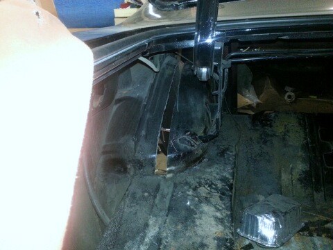 1966 Mercury Comet - The interior of a car's trunk shows signs of wear and tear, with rust and damage visible.