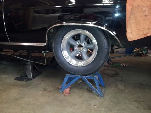 1966 Mercury Comet - Car is up on jack stands, showing the rear wheel and fender area.