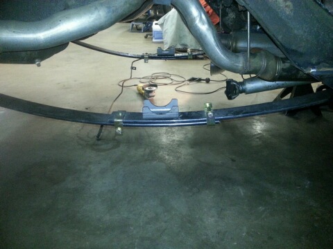 1966 Mercury Comet - Close-up view of vehicle undercarriage components, including leaf springs and exhaust system.