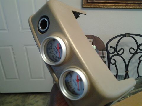 2004 Ford Crown Victoria - A tan dashboard pod with two gauges is shown. The gauges have red needles and white faces with black markings.