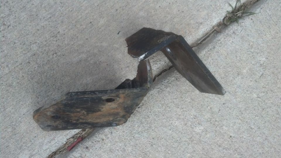 Broken metal bracket on concrete
