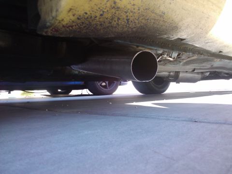 1995 Ford Probe - The underside of a vehicle is visible, focusing on the exhaust system and tires.