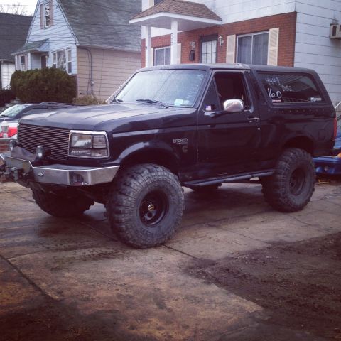 1995 Ford Bronco - This lifted 1995 Ford Bronco features a custom front bumper and aggressive off-road tires.