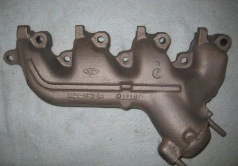 1972 Ford Ranchero - A cast iron exhaust manifold with Ford branding and a date stamp is shown against a neutral background.