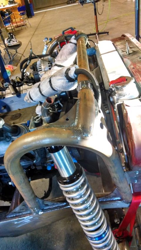 1985 Jeep CJ7 - This vehicle chassis is undergoing modification, with its engine and suspension components clearly visible.