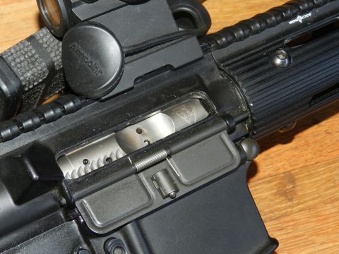 1996 Ford Bronco - Detail of an AR-15 rifle's upper receiver, including the bolt carrier group and charging handle mechanism.