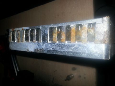 1994 Ford Bronco - Close-up of a corroded metal part with multiple fins, showing signs of age and rust.