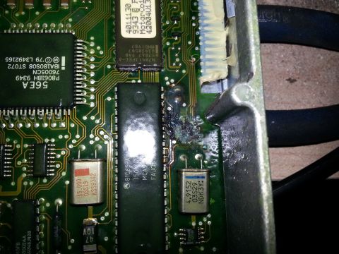 1994 Ford Bronco - This electronic component shows significant heat damage, with melted plastic and burnt traces on the circuit board.