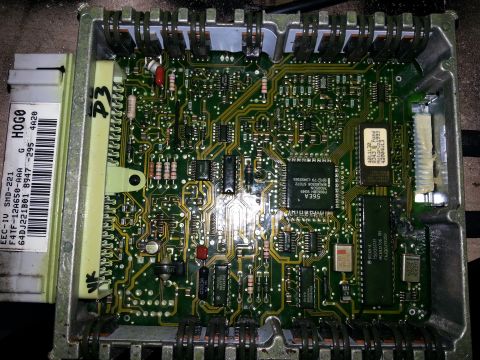 1994 Ford Bronco - Close-up of an engine control unit's internal circuitry, showing various electronic components and connectors.