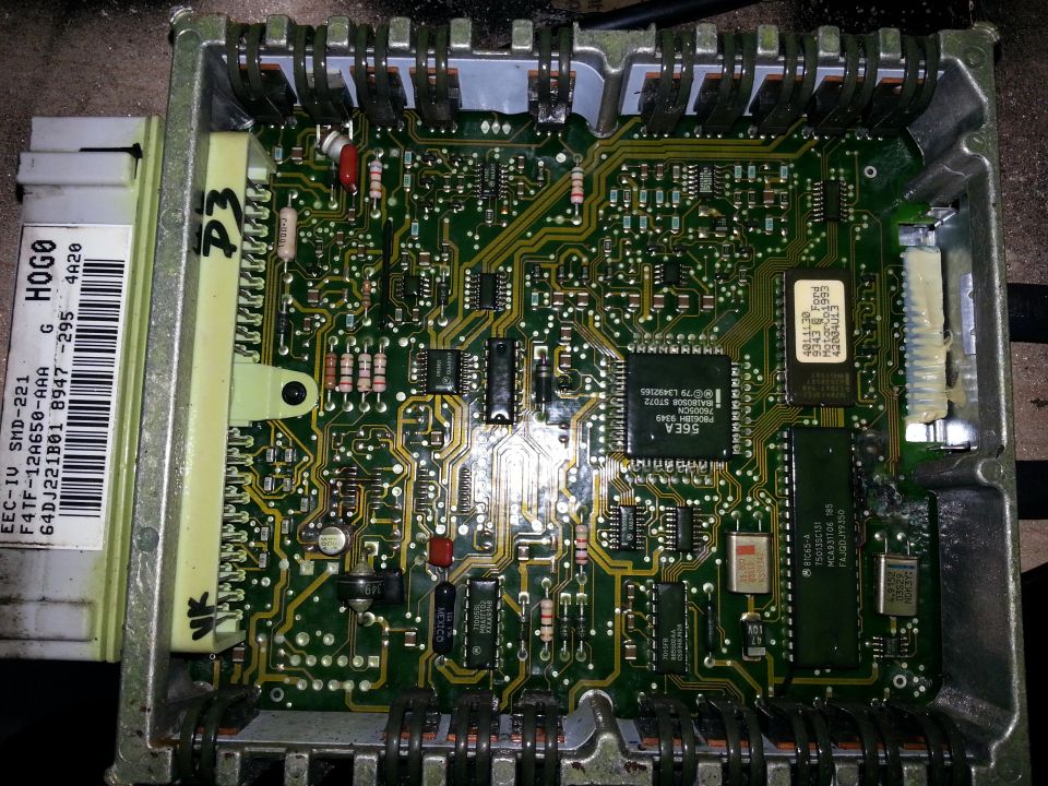 Engine control unit circuit board with visible text 'EEC-IV SMD-221' and 'F4TF-12A650-AAA'