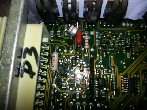 1994 Ford Bronco - An electronic control module with various electronic components, including resistors and integrated circuits, is shown in detail.