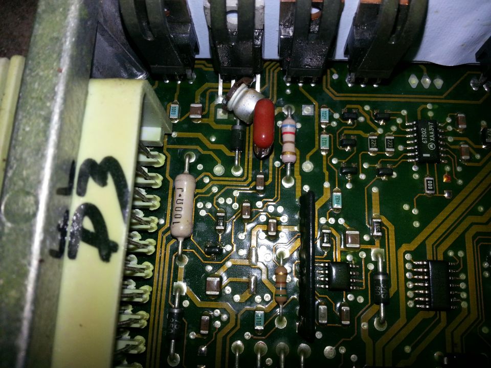 Close-up of electronic control module with visible resistors and chips