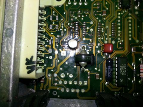 1994 Ford Bronco - Electronic circuit board with various components and a connector. Text 'MEXICO' is visible on a black component.