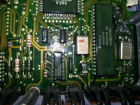 1994 Ford Bronco - This is a close-up view of an electronic control unit's circuit board, showing integrated circuits and other electronic components.
