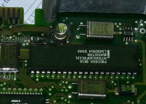 1994 Ford Bronco - Close-up of an electronic circuit board with various components and markings.