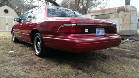 2000 Mercury Grand Marquis - Rear view of a red sedan with a Kansas license plate.