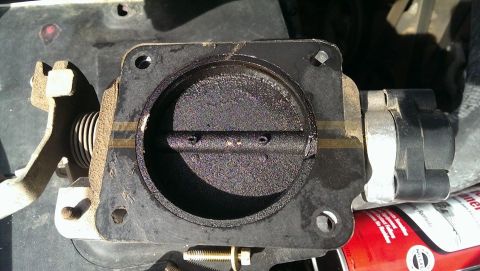 2000 Mercury Grand Marquis - Dirty throttle body assembly with visible carbon buildup on the butterfly valve.