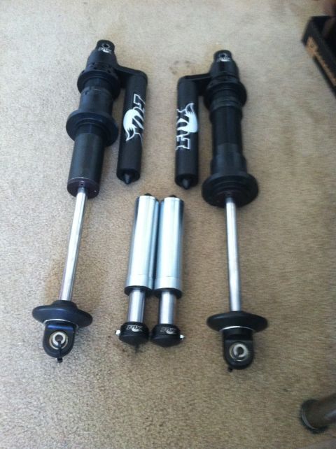 1977 Ford F-350 - Fox shocks and reservoirs shown on carpet. No vehicle is visible.