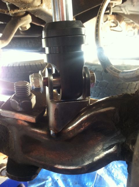 1977 Ford F-350 - Close-up view of a vehicle's suspension system, focusing on a coilover shock absorber.