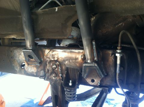 1977 Ford F-350 - Close-up view of custom suspension fabrication on a vehicle's frame.