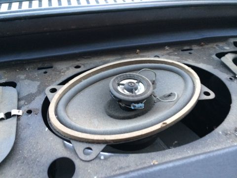 1964 Ford Ranchero - Close-up of a car speaker, likely in a dashboard, showing its condition.