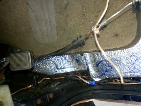 1994 Ford Bronco - Vehicle interior floor with exposed wiring and sound deadening material.