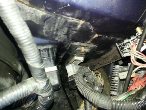 1994 Ford Bronco - Close-up view of electrical connectors and wiring harness in a vehicle's engine bay.