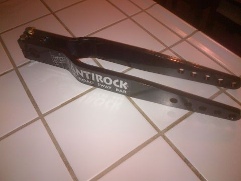 1985 Jeep CJ7 - This is a black anti-roll bar with 'ANTiROCK ROAD SWAY BAR' printed on it.
