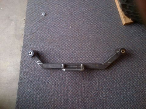 1985 Jeep CJ7 - A custom-fabricated suspension component is shown lying on a carpeted surface.