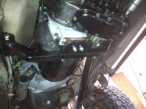 1985 Jeep CJ7 - The underside of a Jeep CJ shows its engine and transmission components, with a visible Supermotors.net watermark.