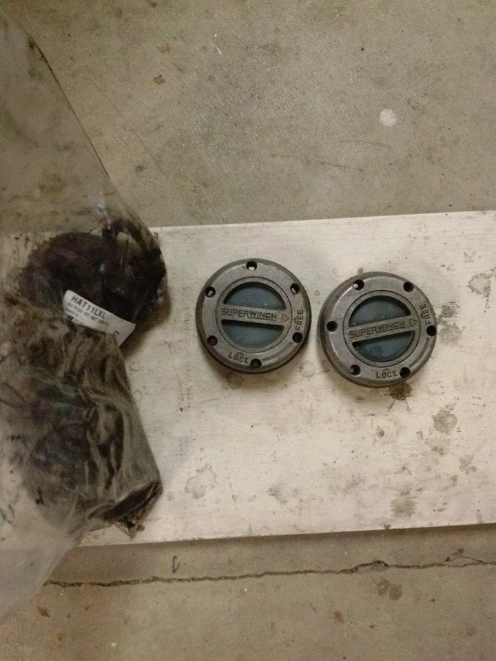 Two Superwinch hubs, one in plastic bag with other parts