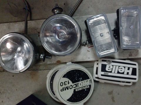 1995 Ford Bronco - Various vehicle lighting components are laid out, including round headlights and rectangular fog lights.