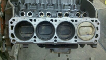 1989 Ford F-150 - Close-up view of an engine block, showing four cylinders with pistons visible in three.