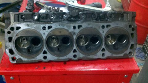 1989 Ford F-150 - A close-up view of an engine cylinder head, showing the intake and exhaust valves for four cylinders.