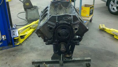 1989 Ford F-150 - Engine block on a stand in a workshop setting. Supermotors.net logo is present.