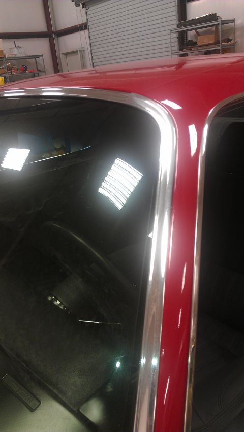 1972 Pontiac Trans Am - Red car's roof and window trim detail, with reflections on the glass.