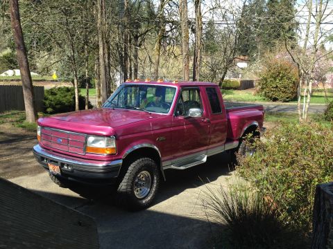 1992 Ford F-150 - This red 1992 Ford F-150 pickup truck is shown from a 3q-front angle.