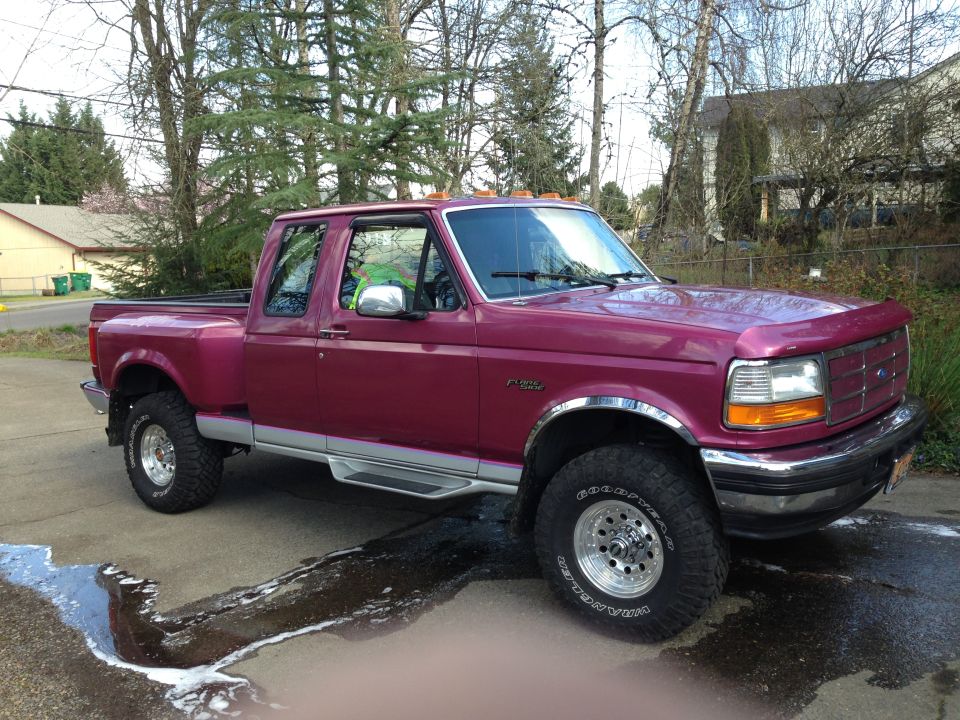 Burgundy OBS Ford Flareside extended-cab pickup, 3/4 front view, freshly washed