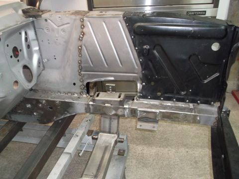 1967 Ford Mustang - Metal fabrication work on a vehicle's chassis, showing structural repairs.