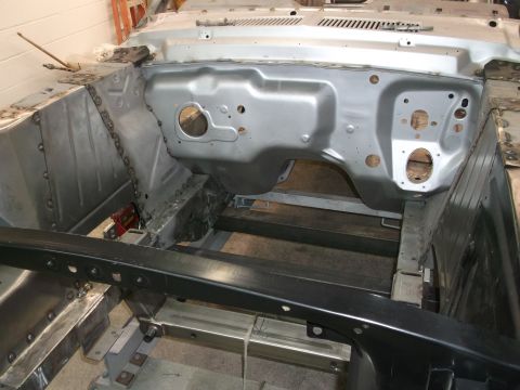 1967 Ford Mustang - The firewall and floor pan of a car undergoing restoration work.