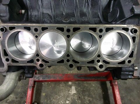 2004 Ford Crown Victoria - Engine block with pistons, "JWR" engraving on the piston tops.