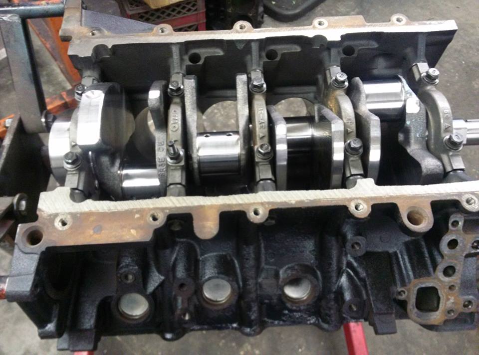 V8 block bottom end with polished crankshaft installed under cross-bolted main caps