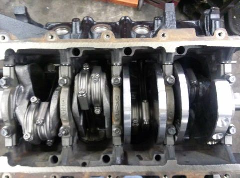 2004 Ford Crown Victoria - Close-up view of an engine's crankshaft and connecting rods, showing internal mechanical components.