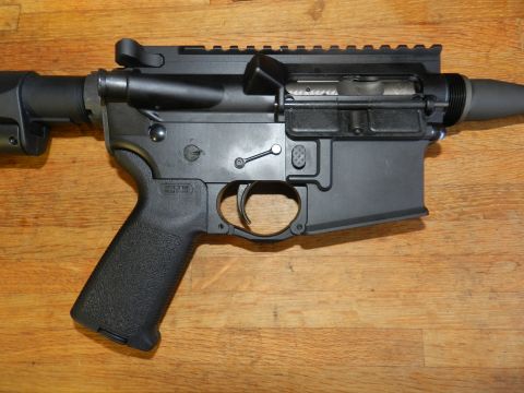 1996 Ford Bronco - Close-up view of an AR-15 lower receiver, showing the grip, trigger, and magazine well.
