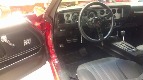 1972 Pontiac Trans Am - The interior of a classic car features a dashboard with gauges, a steering wheel, and a center console with an automatic shifter.