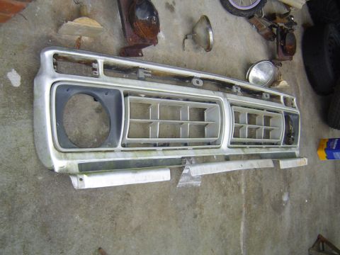 1986 Ford Bronco - This is a Ford truck grille, likely from a 1973-1979 F-Series model, lying on concrete.