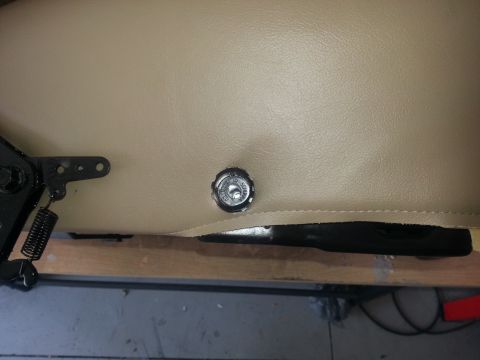 1994 Ford Bronco - A close-up view of a vehicle seat's adjustment knob and mechanical components.